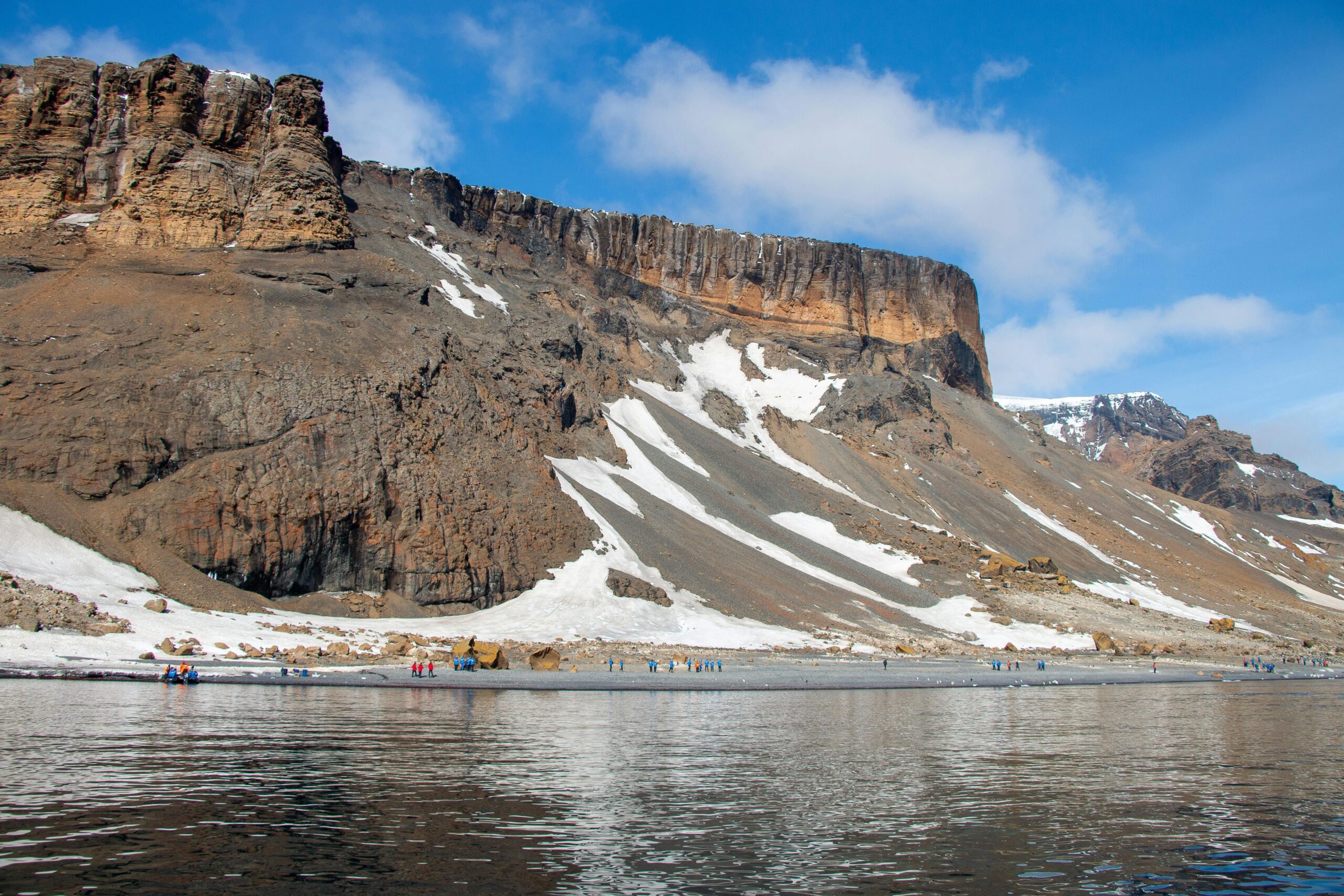 Rust-colored cliffs and Adélie Penguins at Brown Bluff.