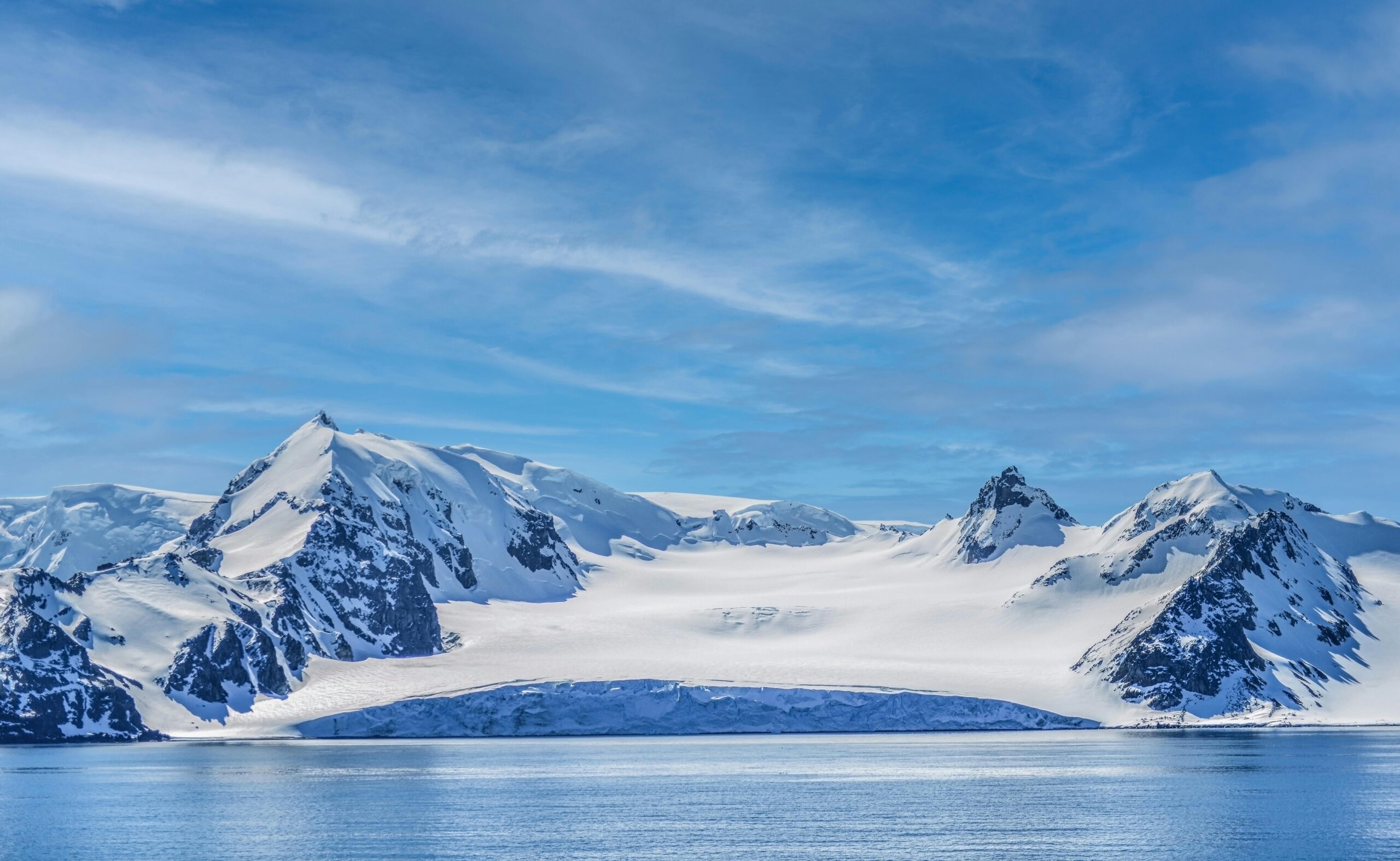 A ship winding through the high peaks of the Neumayer Channel.